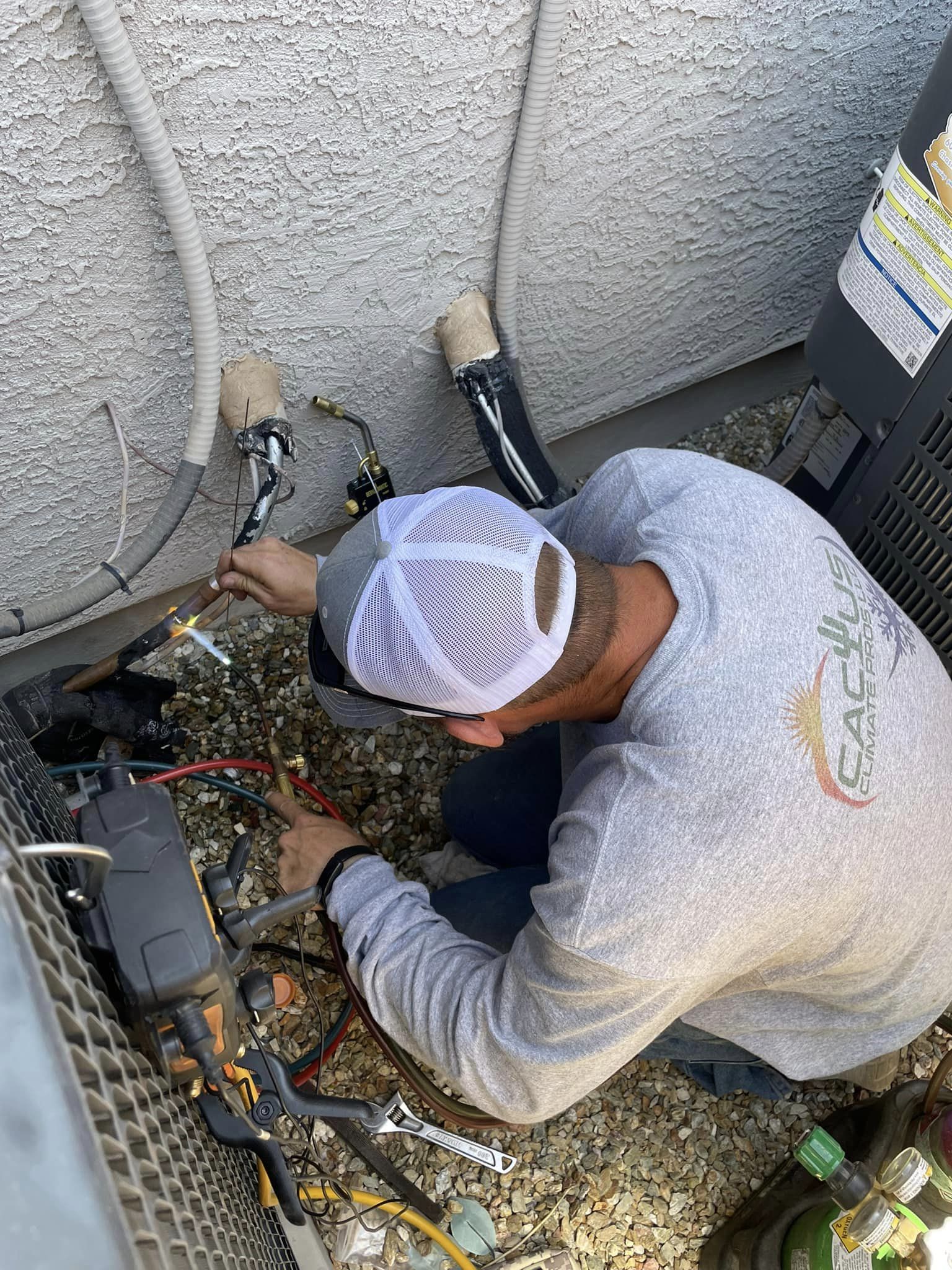 Cactus Climate Pros working on Air Conditioner